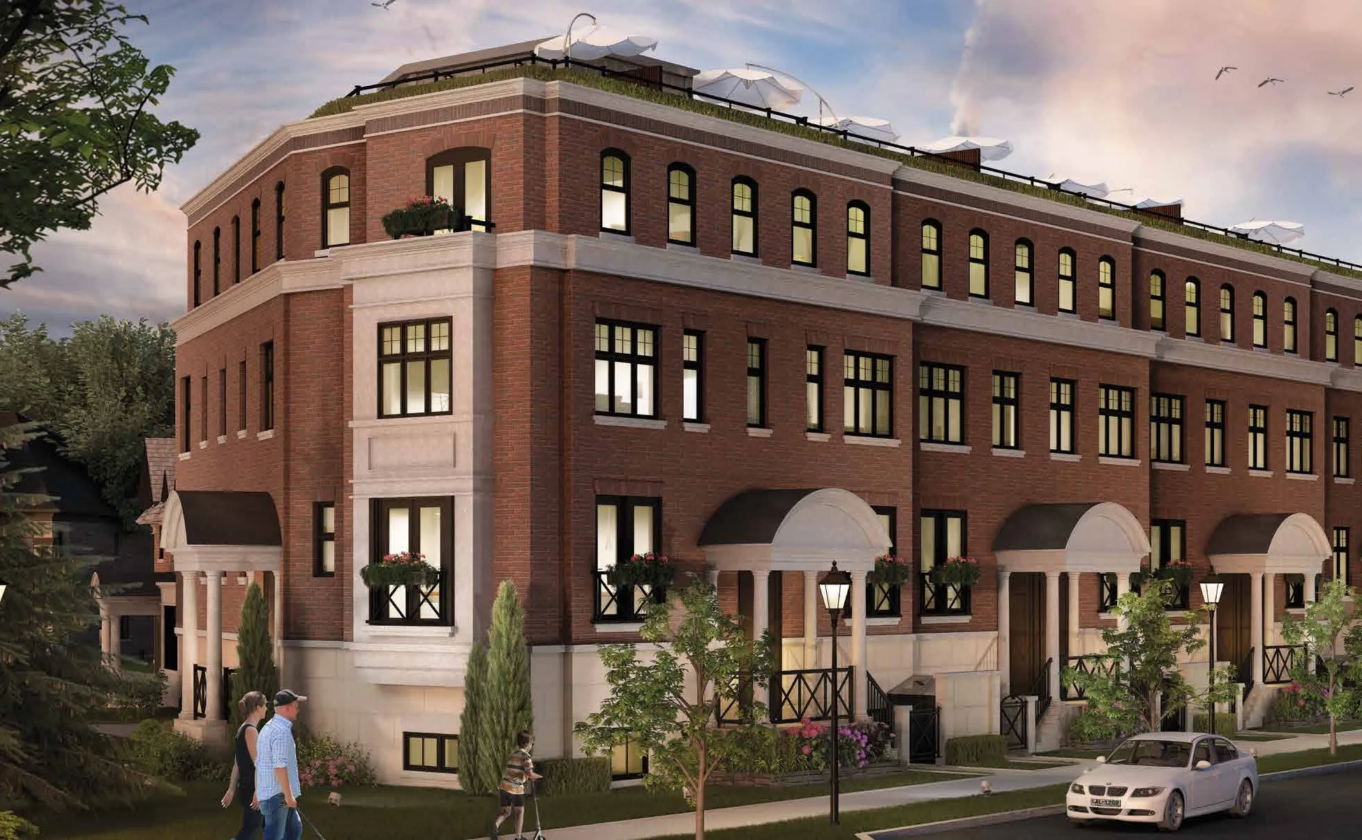 Rendering of Leaside's red-brick townhomes with arched porticos at dusk.