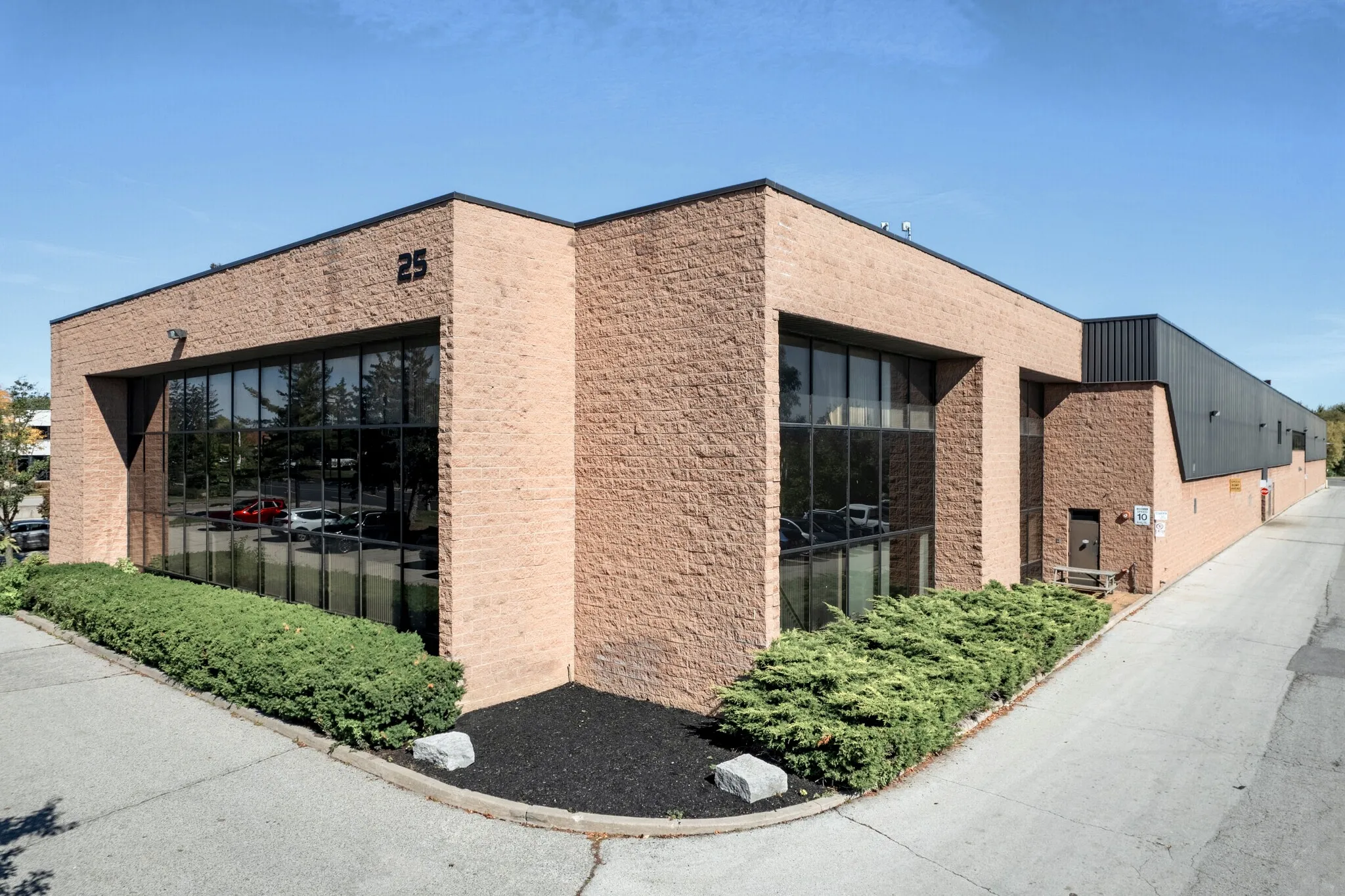 Photo of the building's corner with the number 25 and tinted windows.