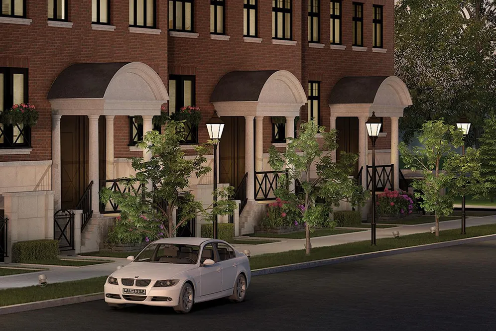 Rendering of townhome entrances with columned porticos and street lamps at night.